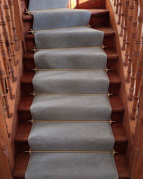 Grey runner with brass stair rods on oak stairs