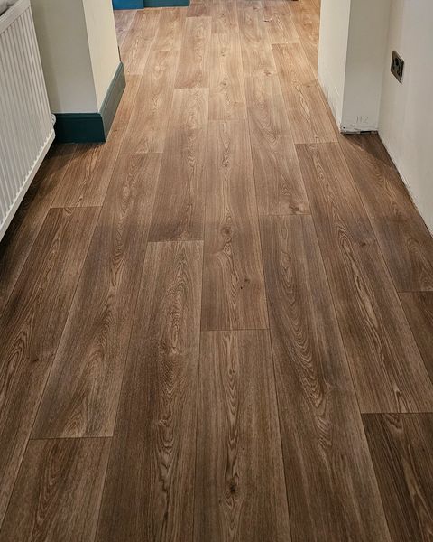 Dark oak-effect vinyl fitted in a hallway